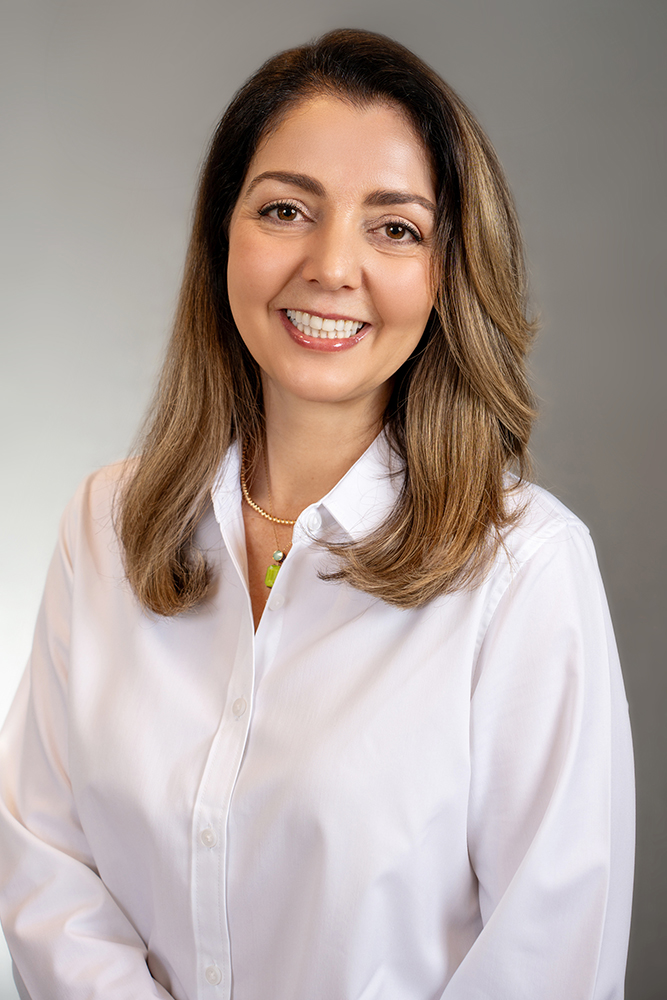 Professional headshots in New York, NY - a headshot of a woman wearing a white shirt