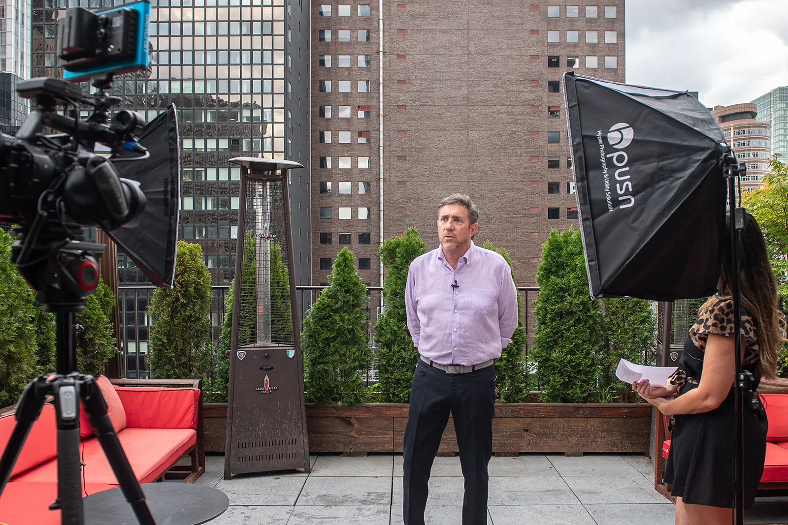 A corporate employee being filmed for content at a corporate event